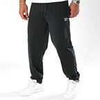 Reebok Jogging Noir Tissé, vue de trois quarts avec chevilles élastiquées, BirdNova Algérie