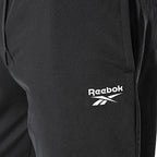 Reebok Jogging Noir Tissé, gros plan sur le logo blanc de la cuisse, BirdNova Algérie