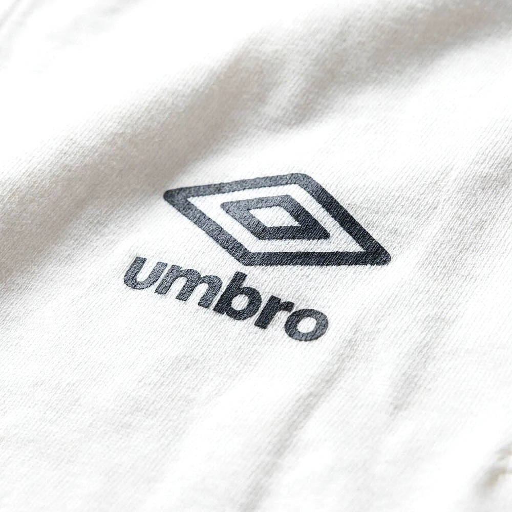 Umbro Polo Blanc — logo double diamant foncé, original BirdNova Algérie